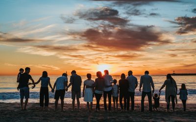 people standing on shore during golden hour